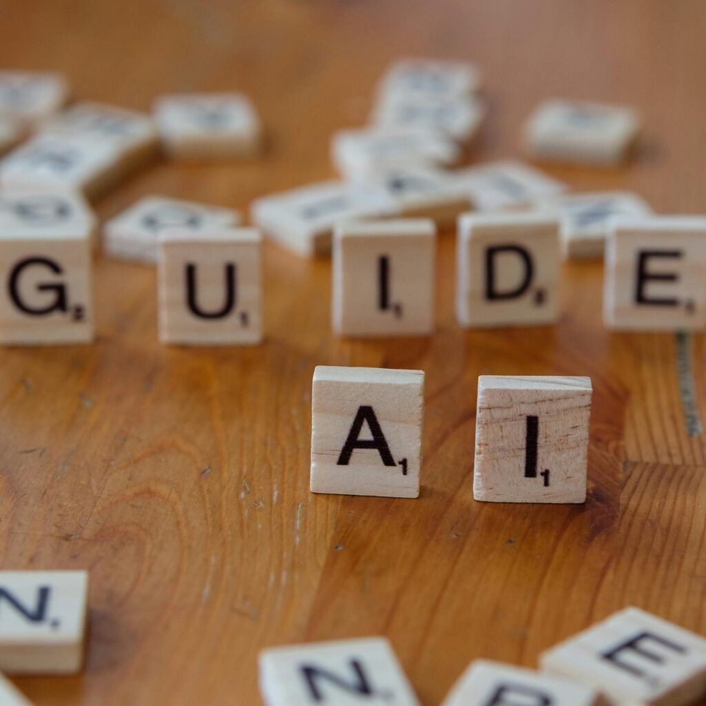 Scrabble letters spelling 'GUIDE' and 'AI' on a wooden surface, suggesting direction and technology.